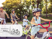 Happy family is riding bikes outdoors and smiling. Little girl in the foreground